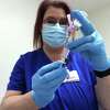 Andrea Spears fills a syringe with the 1/2 millimter dose of the Moderna COVID-19 vaccine at Christus of Southeast Texas Jasper Memorial Hospital Tuesday as first shots for healthcarre workers got underway. Photo taken Tuesday, January 5, 2021 Kim Brent/The Enterprise