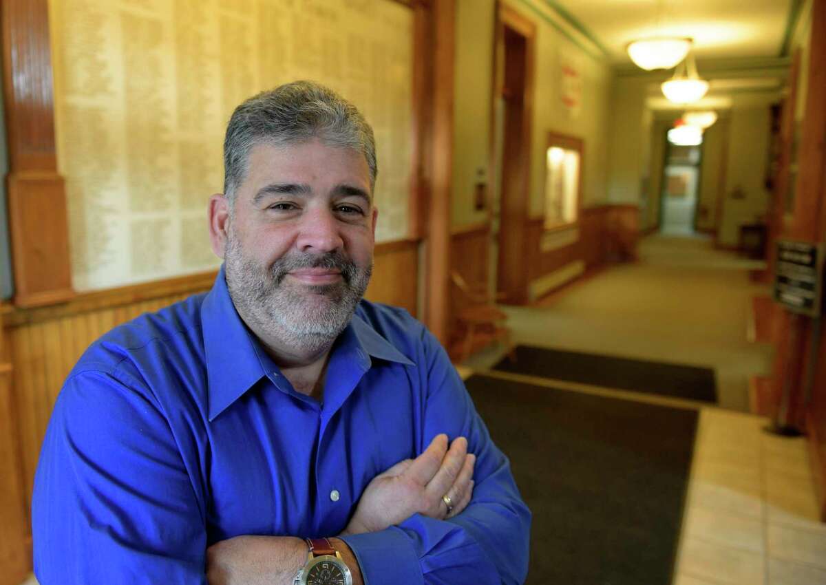 New Milford Mayor Pete Bass stands in the entrance to Town Hall in an image from 2017.