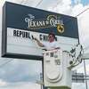 After installing the new sign for The Texana Grill, Cody Teems of Image 360 Beaumont removes the lettering on the former Republic Chicken sign. By next week, the eatery on Interstate 10 near Beaumont???s hotel corridor will be transforming to The Texana Grill. Photo made on August 5, 2020. Fran Ruchalski/The Enterprise
