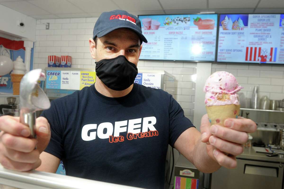 Co-owner Justin Ragusa holds an ice cream cone at Gofer Ice Cream, in Greenwich, Conn. Feb. 22, 2021. The ice cream shop just re-opened after a major fire in 2019. Golfer has announced it plans to open a new location soon in Stamford’s Ridgeway Center.