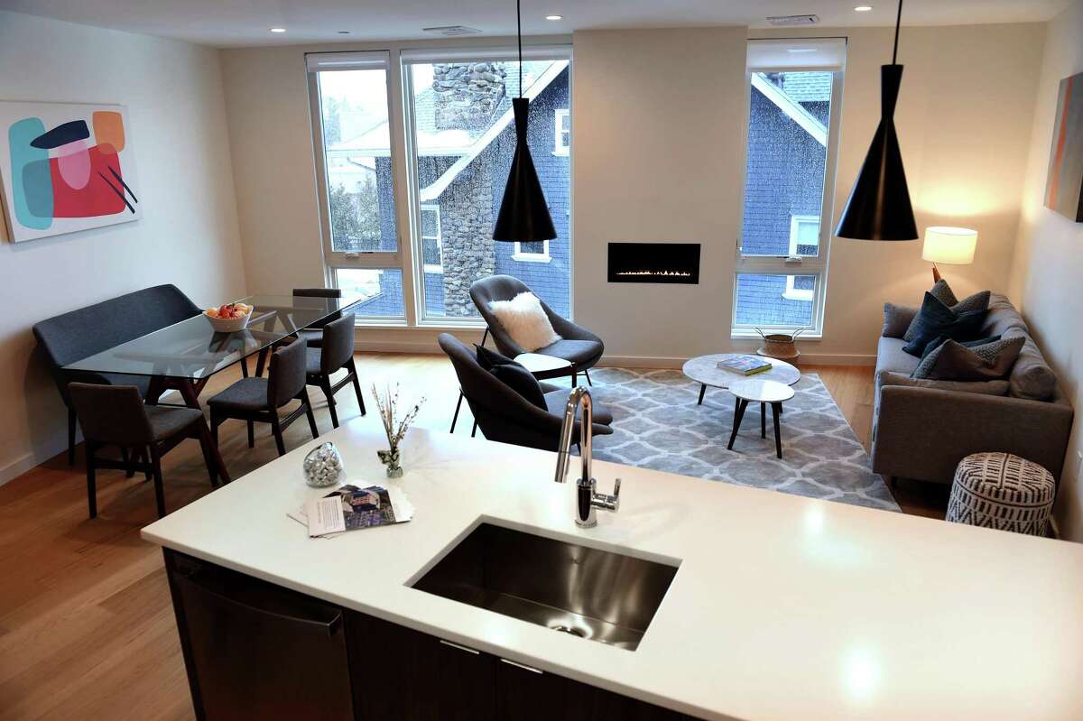 The living room/dining room/kitchen in an open floor of a two-bedroom apartment at the Whitney Modern in New Haven on Feb. 22, 2021. A 1,003-square-foot, two-bedroom and two-bathroom unit in the building can be rented for $2,950 a month, said leasing manager Kristen Perkins. According to the Whitney Modern’s website, the least expensive unit available is a 632-square-foot, one-bedroom apartment for $1,840 monthly. The units boast floor-to-ceiling windows and hardwood floors. Greenberg said the units in the building follow an open-floor plan. According to Greenberg, all but 11 of the units in the Modern are currently leased. The units range from 632 to 1,203 square feet.