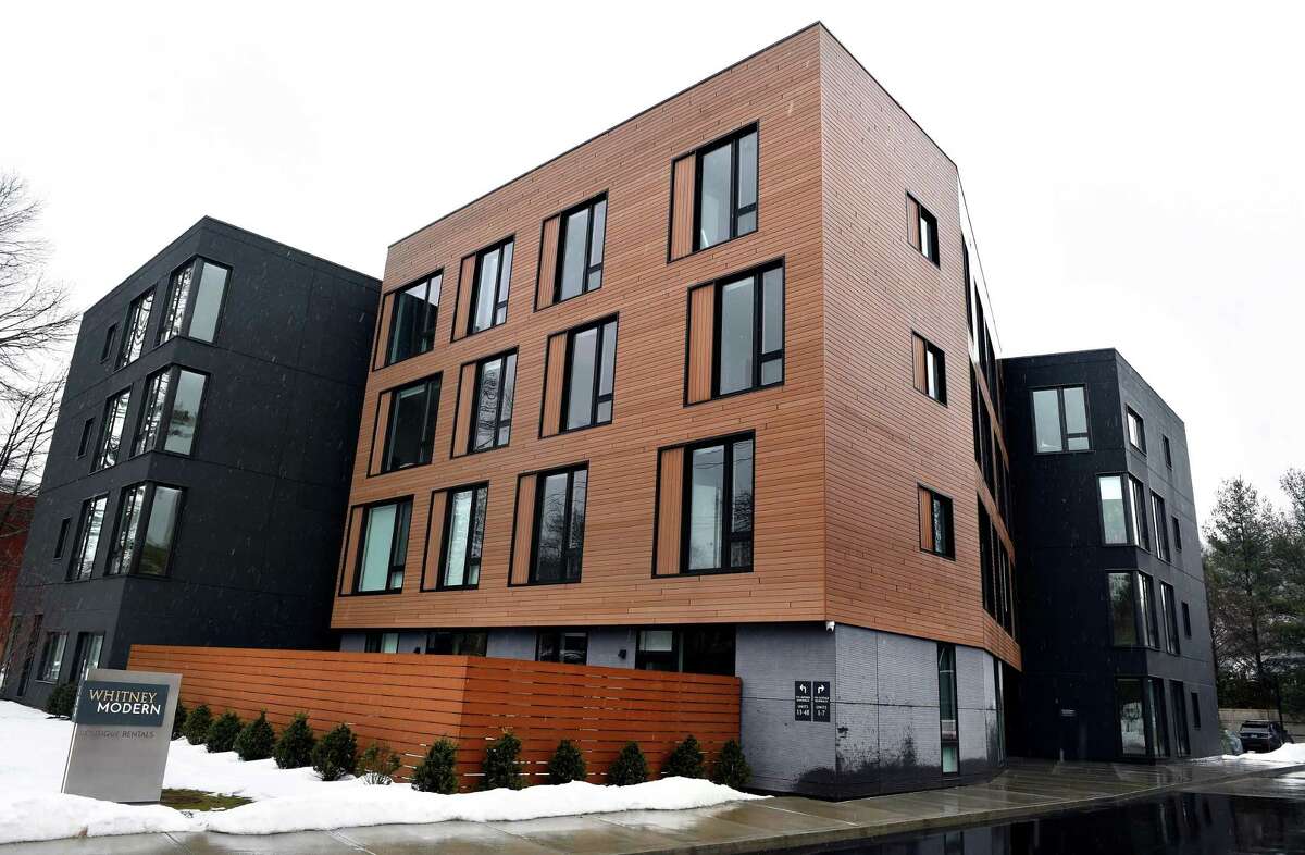 The Whitney Modern apartment community in New Haven photographed on Feb. 22, 2021. The Modern New to the lot is a four-story building with 35 one- and two-bedroom apartments. Charlie Kaplan, a design principal at architectural firm GLUCK+, said the building was designed to be “in conversation” with The Cottage. He said the driveway to the parking lot behind the buildings was designed to resemble a road, creating a plaza environment where the architects could play with The Cottage’s scale and space. “You can see its full form,” he said of The Cottage, with more of its side and rear now visible from the street.