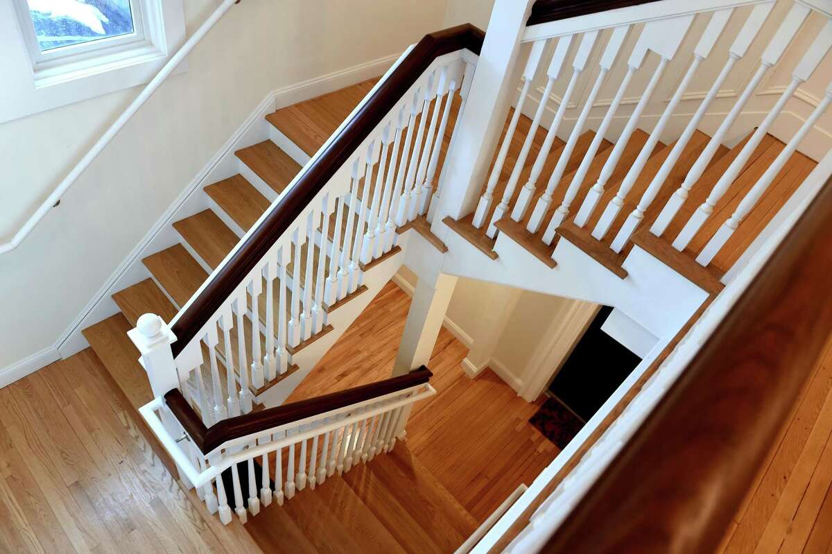 A reconstructed staircase in the Abner Hendee home that is one of the buildings in the Whitney Modern apartment community in New Haven on February 22, 2021. The Abner Hendee House Now called “The Cottage” within the complex, the Abner Hendee House was built in 1902 according to the New Haven Preservation Trust. Lead developer Nancy Greenberg, a New Haven native, said she recognized the potential to both preserve and develop a city landmark. The building retains its colonial-era shingle style architecture, but has been divided into seven units, ranging from 810 to 2,225 square feet. Greenberg and her team preserved the original paneling and oak floors and restored a grand central staircase in the building, adding bathrooms and kitchen spaces to each of the seven units. Greenberg said the building is currently fully leased. The building was zoned for one family until it was purchased by the American Red Cross as its local headquarters and converted into an office space