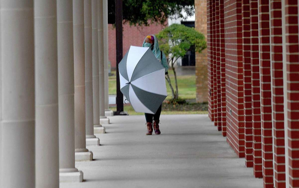 Students at Lamar University had rainy campus treks Thursday afternoon as showers and dropping temperatures moved into the region. Photo taken Thursday, February 11, 2021 Kim Brent/The Enterprise