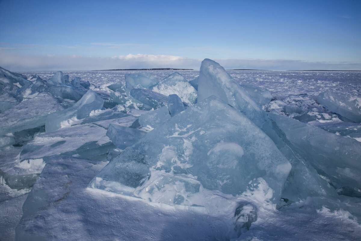 Visitors explore blue ice near Mackinac Bridge - Feb. 22, 2021