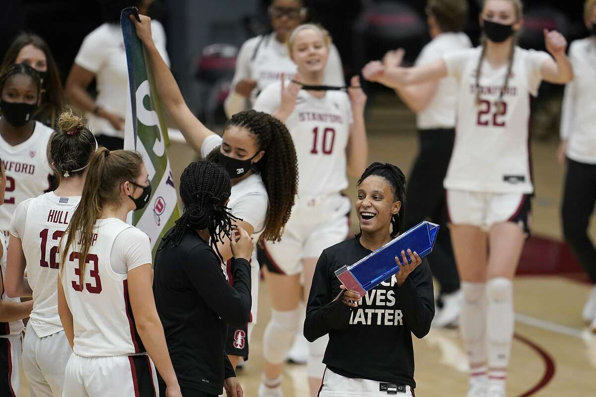 Stanford guard Kiana Williams, bottom right, celebrates with teammates after Stanford defeated Arizona in an NCAA college basketball game in Stanford, Calif., Monday, Feb. 22, 2021. (AP Photo/Jeff Chiu)