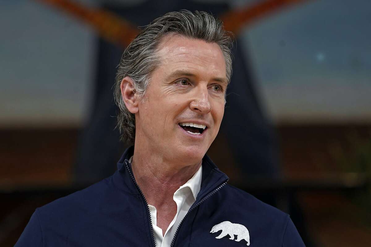 FILE - In this Feb. 21, 2021, file photo, California Gov. Gavin Newsom takes questions from the media during a visit to a mobile vaccination site at Ramona Gardens Recreation Center in Los Angeles.