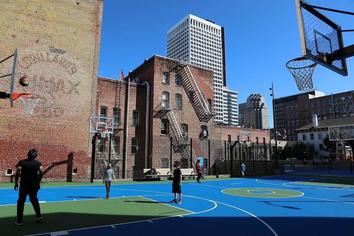 Richard Chock of San Francisco plays basketball with sons Adam, 10, and Nate, 11, at the Willie “Woo Woo” Wong Playground.
