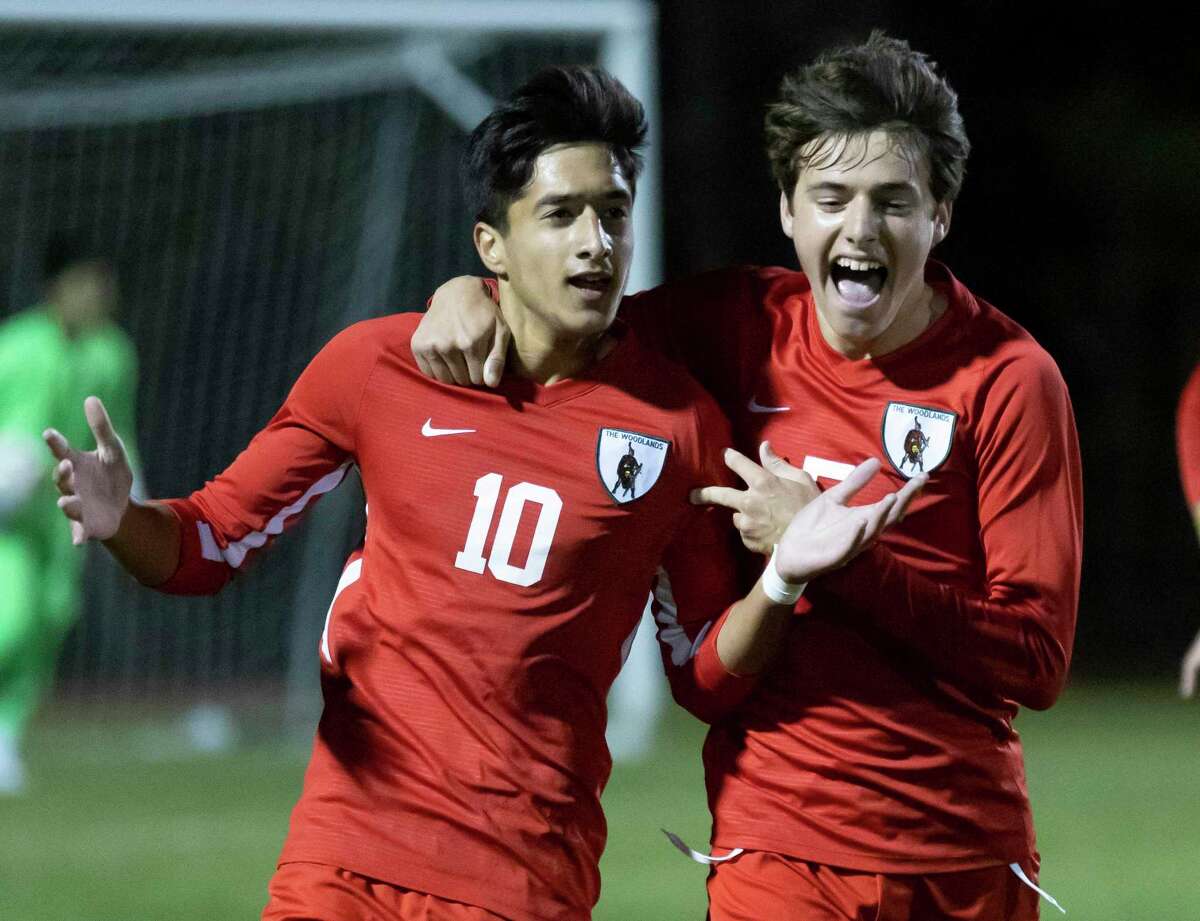 The Woodlands midfielder Andrew Davison (5) and midfielder Hasan Arif (10) react after they score during the first half of a District 13-6A boys soccer against Conroe at The Woodlands High School, Tuesday, Feb. 23, 2021, in The Woodlands.