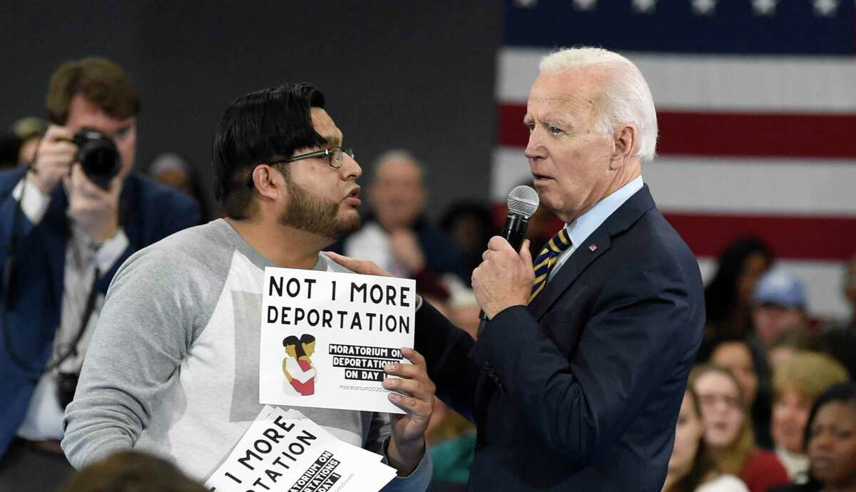 Democratic presidential hopeful Joe Biden talks with a protester objecting to his stance on deportations during a town hall at Lander University in Greenwood, S.C., on Thursday, Nov. 21, 2019. President Joe Biden's administration has deported hundreds of people in its first days in office despite the president's campaign pledge to halt most deportations at the beginning of his term. It’s unclear how many of the people deported in recent days are considered national security or public safety threats or recently crossed the border illegally, as prescribed by new guidance issued by Biden’s Department of Homeland Security to enforcement agencies. That guidance went into effect Monday, Feb. 1, 2021. (AP Photo/Meg Kinnard, file)