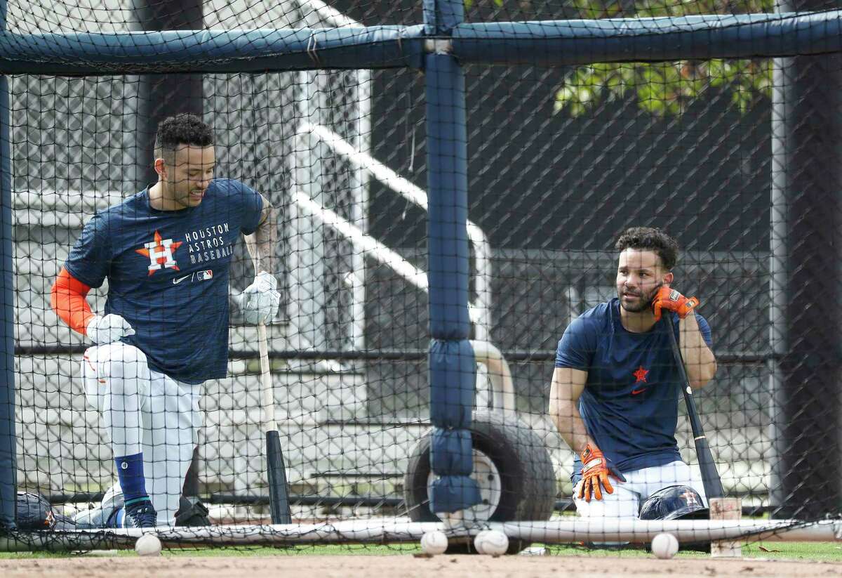Houston Astros Carlos Correa and Jose Altuve during batting practice during the third day of full-squad workouts for the Astros at Ballpark of the Palm Beaches in West Palm Beach, Florida, Wednesday, February 24, 2021.