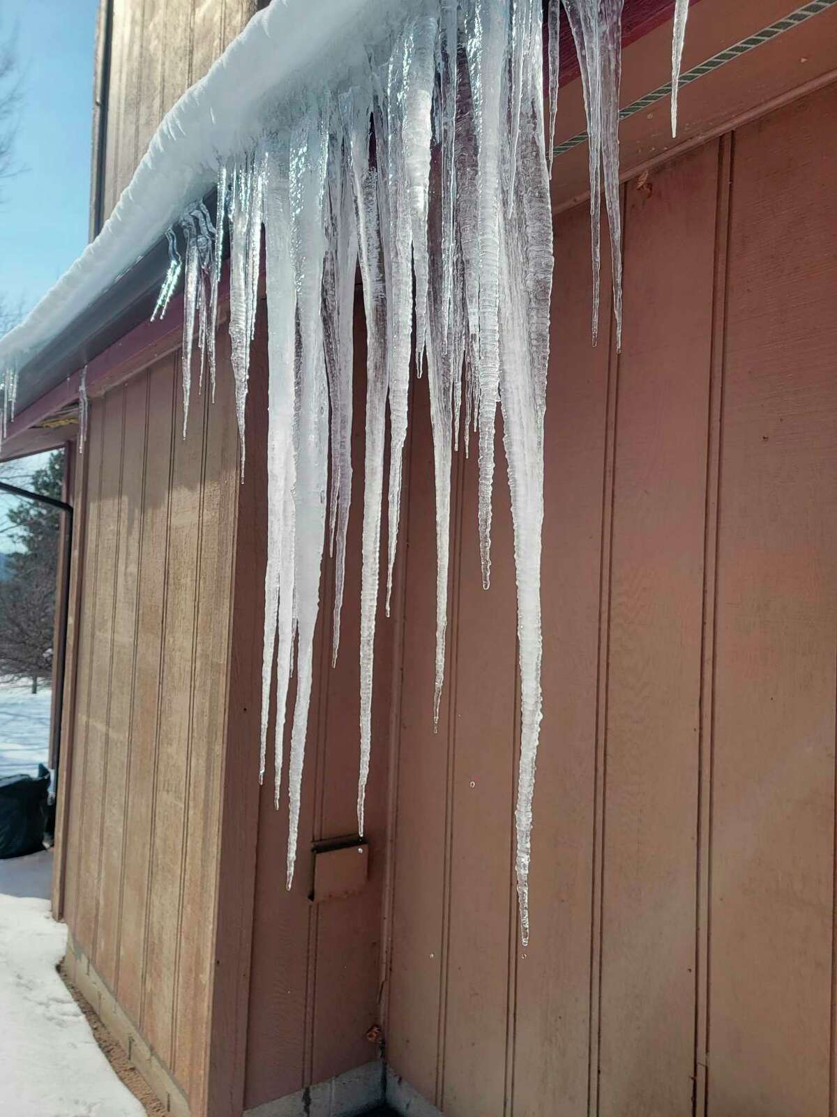 Ice dams can form when snow on a heated roof melts and then freezes further down on the unheated eaves. (Colin Merry/Record Patriot)