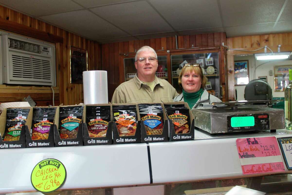 Jim Tighe and his wife bought the M-55 market in 1985. They are pictured here in a photo from 2015. (File photo)