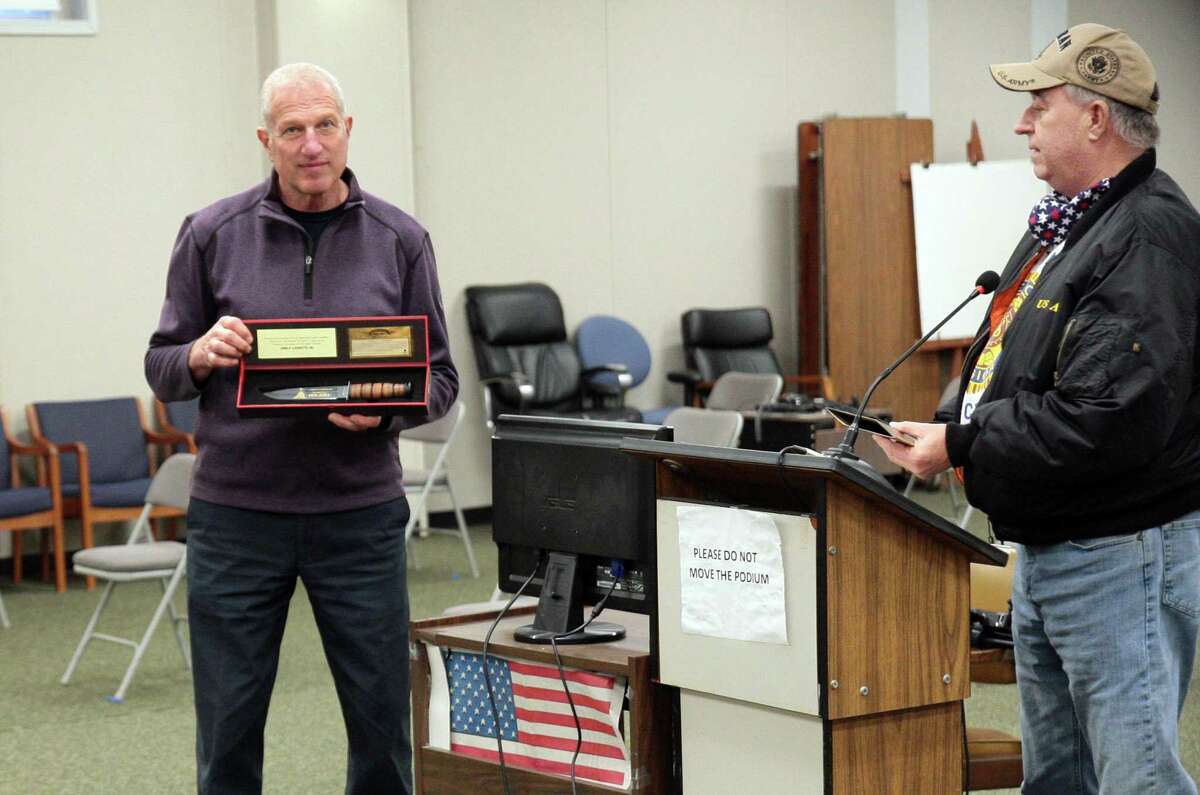 American Legion Post 16 Commander Dave Gallagher, right, presented Mayor Mark Lauretti an Iwo Jima commemorative knife on the 76th anniversary of the flag raising on the Japanese Island during WWII, before the start of the Board of Aldermen meeting at Shelton City Hall in Shelton, Conn., on Tuesday Feb. 23, 2021.