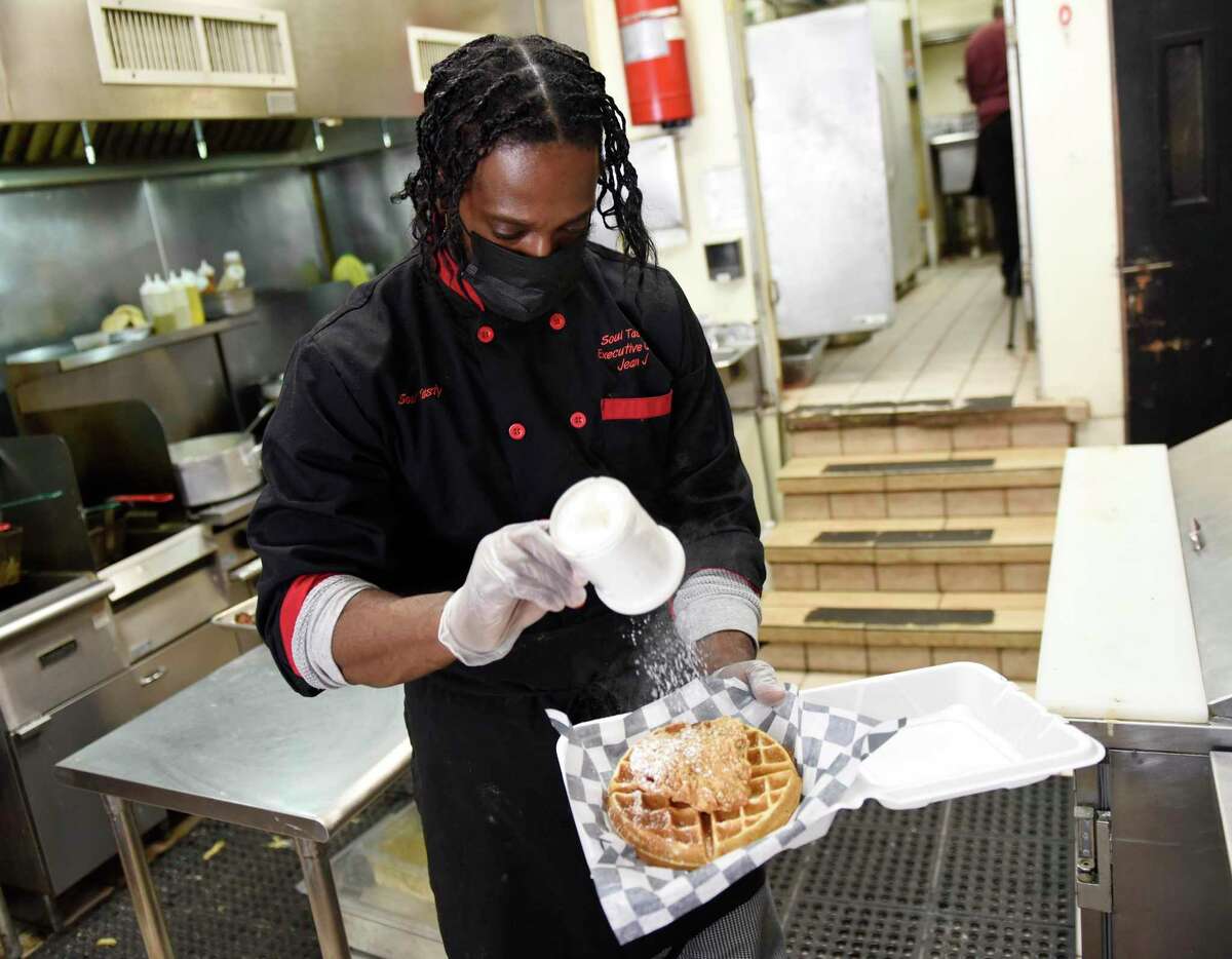 Co-owner Jean Gabriel makes chicken and waffles at Soul Tasty in Stamford on Wednesday. Lt. Gov. Susan Bysiewicz celebrated Black History Month by visiting Soul Tasty, a Black-owned restaurant in Stamford, and encouraging consumers to shop local and support Black-owned businesses.