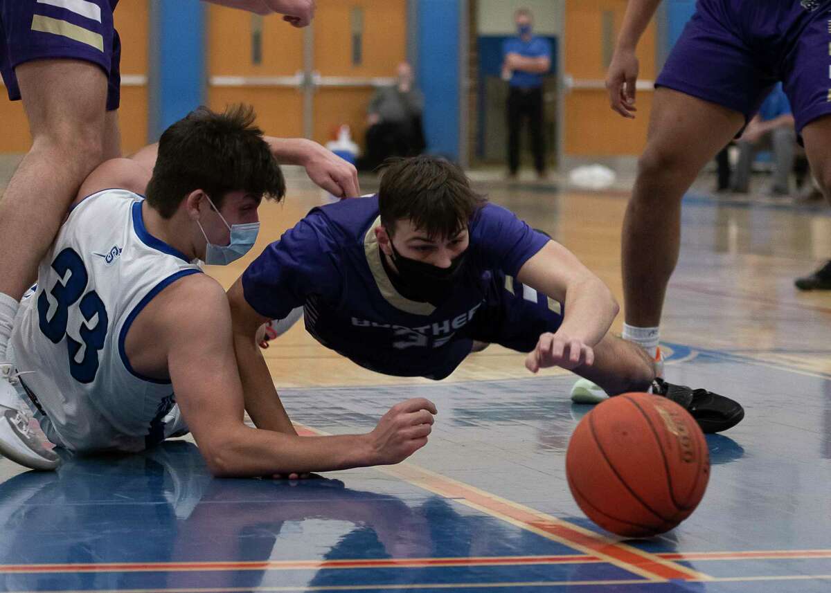 Saratoga's Chris Dufort and CBA's Colby Dodson reach for the ball during a game on Wednesday, Feb. 24, 2021, in Saratoga Springs, N.Y. (Jenn March, Special to the Times Union)