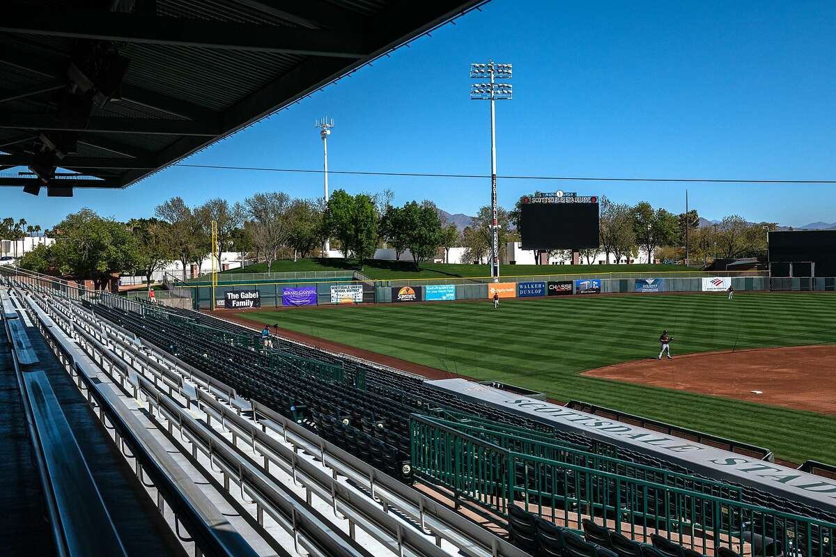 The typical masses of staff, spectators and press are missing from the first day of San Francisco Giants practice at Scottsdale stadium before opening day of Spring Training in the Cactus League, on Monday, Feb. 22, 2021, in Scottsdale, Ariz..