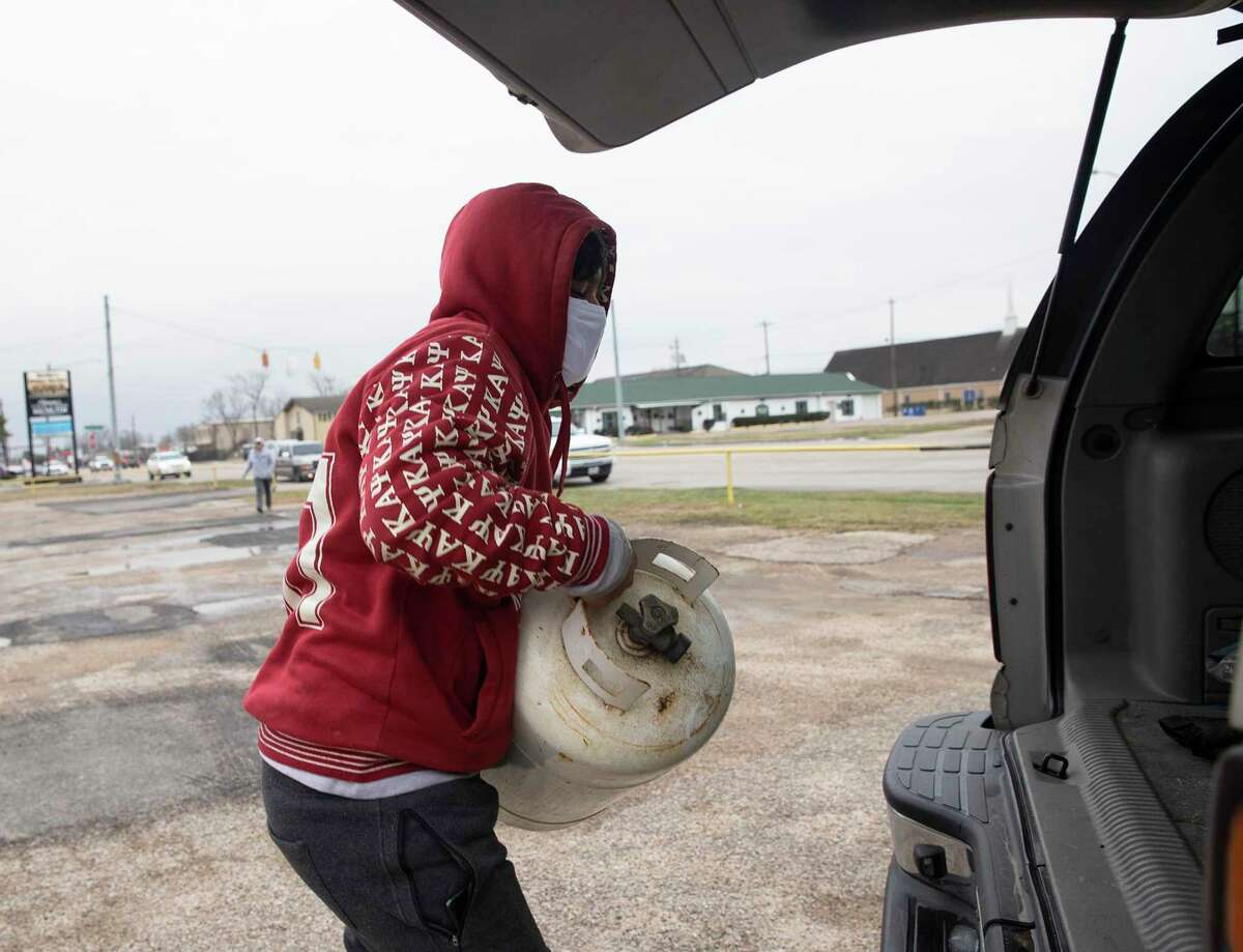 Issac Blandon loads a propane cylinder into his family's car Tuesday, Feb. 16, 2021, in South Houston. The family got the last bit of propane in South Houton at KKI Rentals. Two propane suppliers in City of South Houston were out of propane before 3 p.m. The demand of propane was high due to the unusual circumstances. Hunt said he he is not sure when he will receive the next delivery from Baytown.