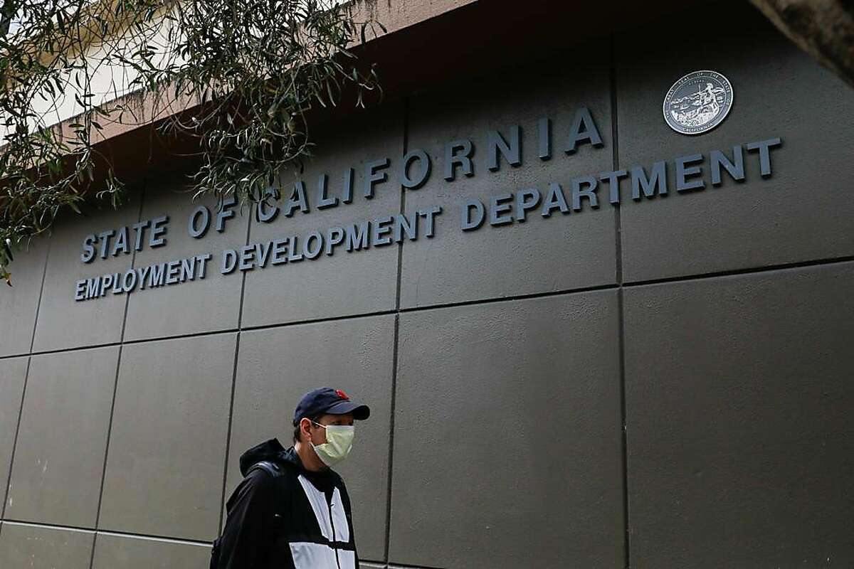 A man walks by the Employment Development Department office in San Francisco.