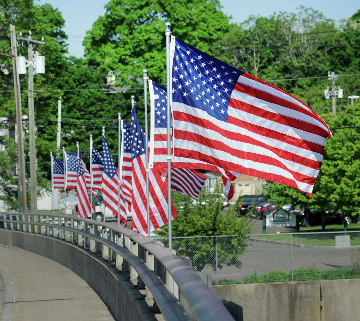 The American flags are up on the David N. Theis Memorial Bridge that spans the Mianus Waterway in Greenwich, Conn., Friday, May 25, 2018. A similar program could be coming to Greenwich Avenue this summer.