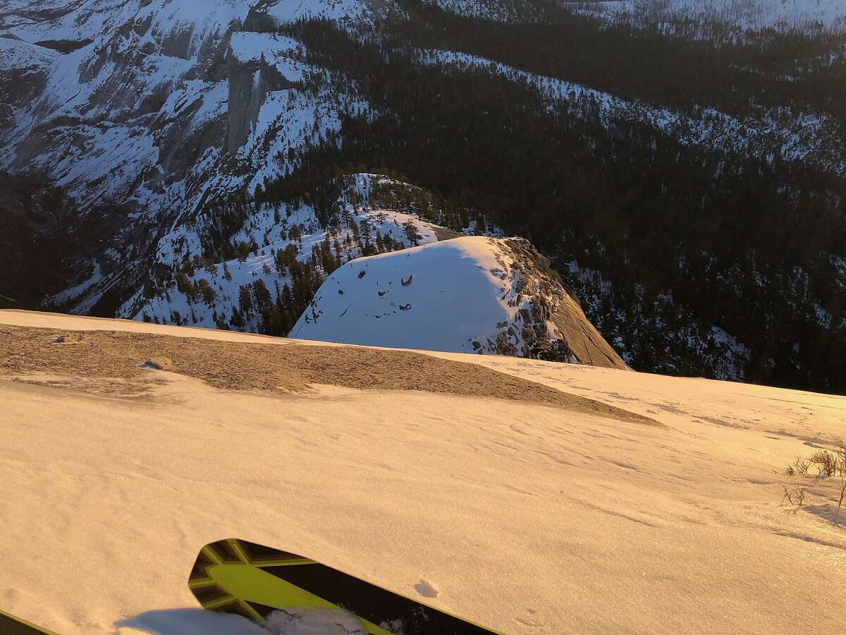 Jason Torlano looks over his ski tips down the steep slope of Half Dome during the ski descent