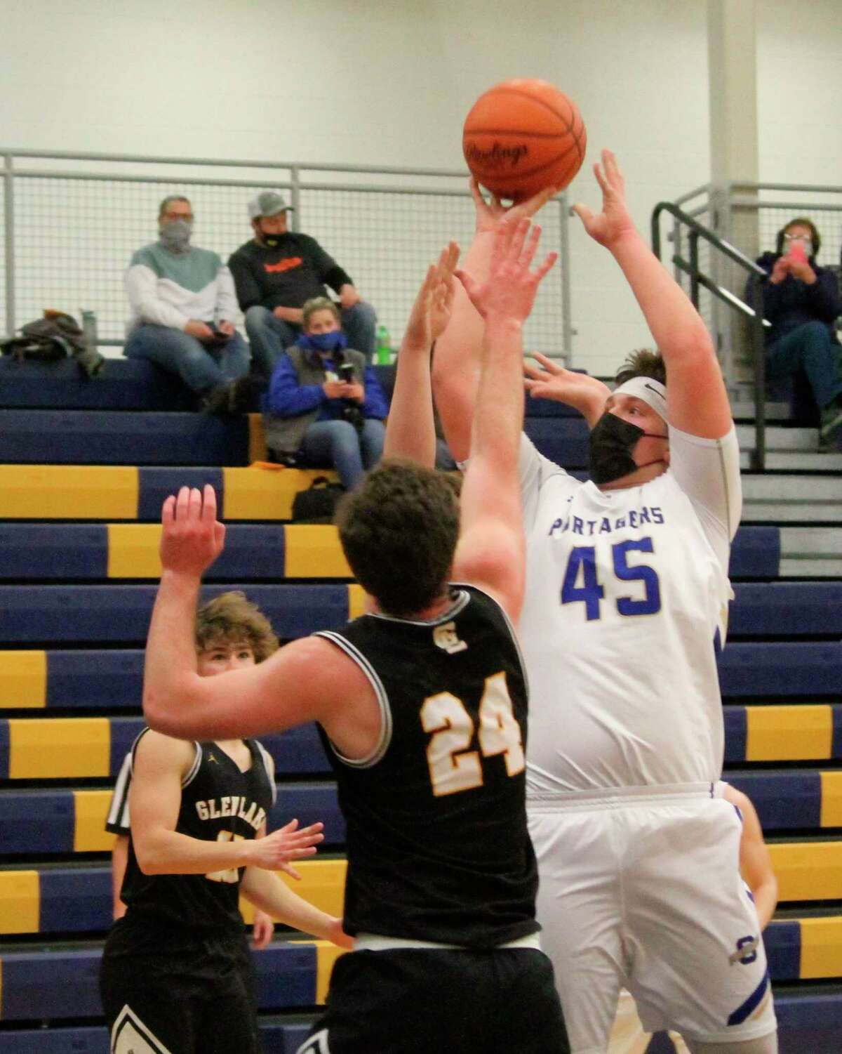 Ben Falk elevates over the Glen Lake defender for a shot on his way to a team-high 12 points on Feb. 25. (Robert Myers/News Advocate)