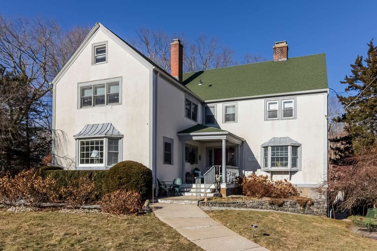 Vintage stucco colonial house at 949 Boston Post Road, Madison.