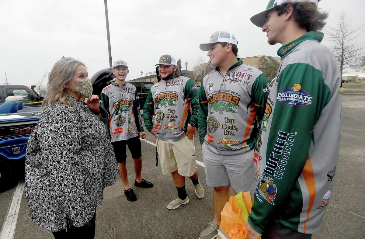 From left, annglers Jack Tindel, Brett Fregia, Grady Doucet and Trent Buccholz joke with Dr. Wendy Elmore as she hands them a gift and well wishes from their proud college staff during a spirited send-off for Lamar State College Orange's fishing teams as they head to the national championship Thursday. Photo made Thursday, February 25, 2021 Kim Brent/The Enterprise