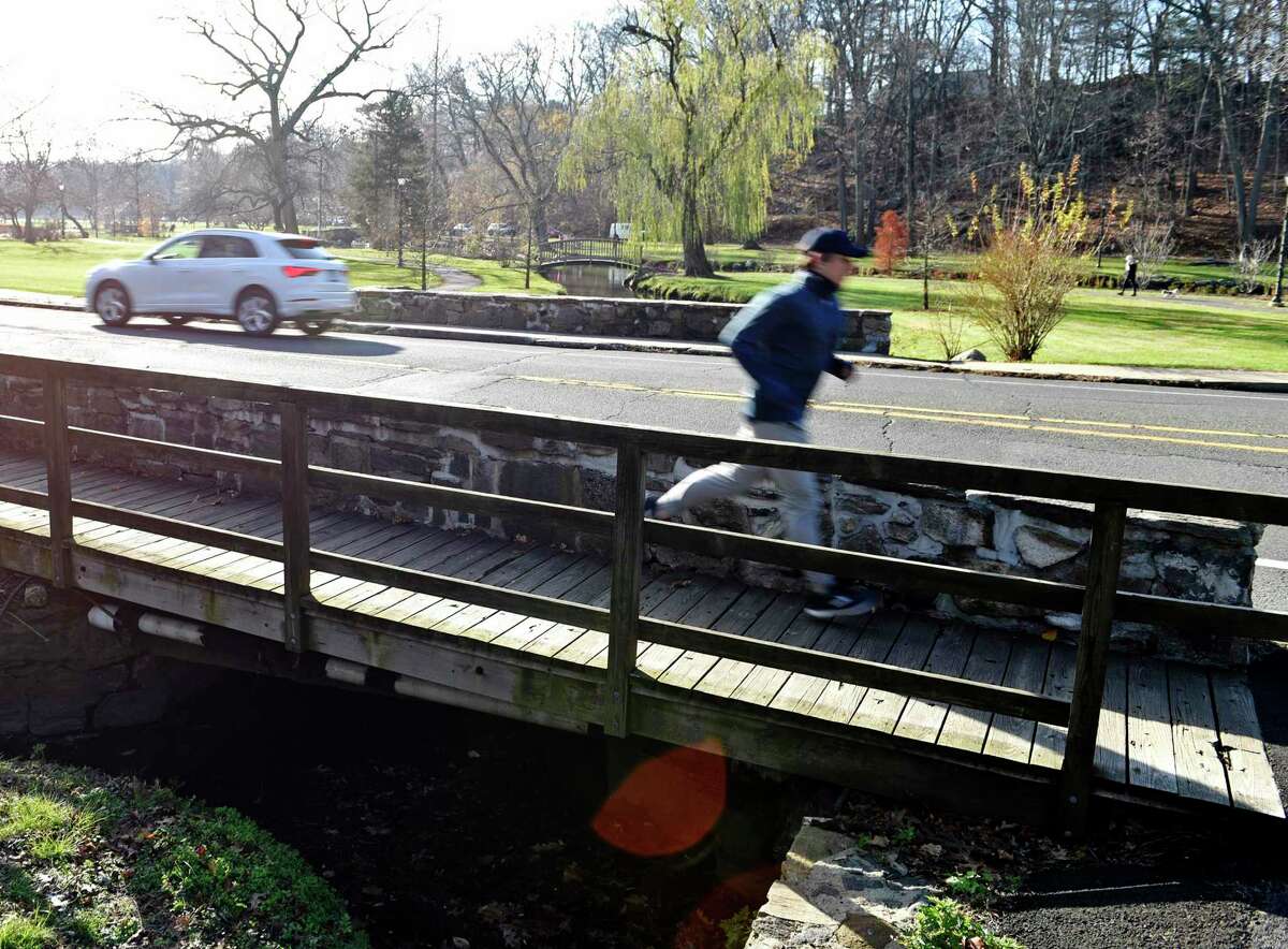 A runner jogs across the bridge on Sound Beach Avenue near Binney Park in Old Greenwich, Conn. Thursday, Dec. 3, 2020. The bridge is slated to be replaced and a detour has been approved for July for vehicles and pedestrians.