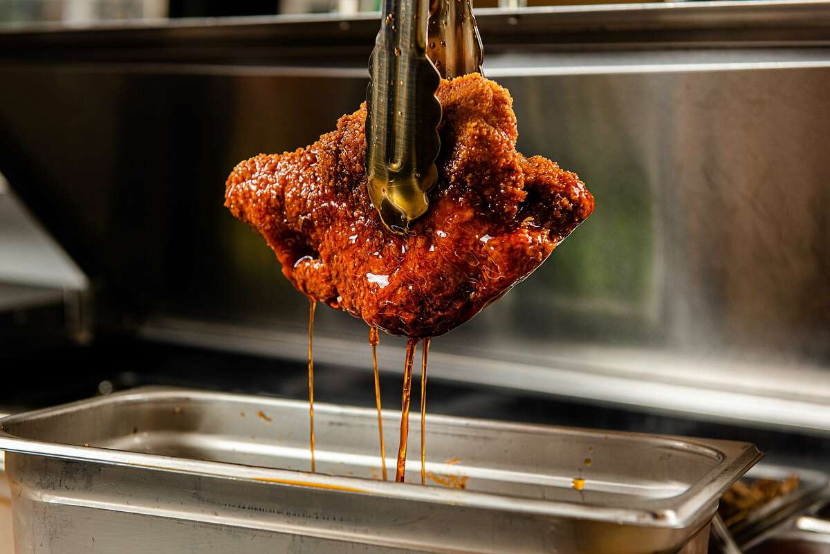 A crispy chicken thigh comes out of the fryer at Oakland’s Square Pie Guys for a hot calabrese chicken sandwich.
