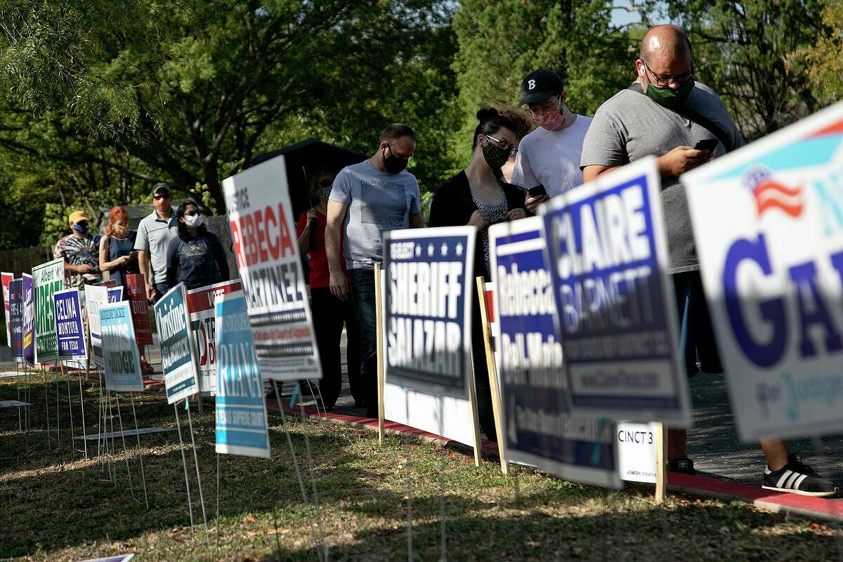 People wait in line to vote at Edmund Cody Branch Library in San Antonio on October 14, 2020.