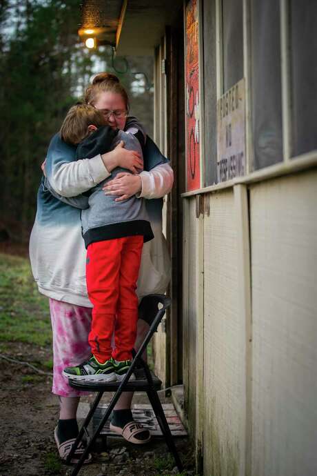 Alex Blanchard hugs her son, 9, outside their Hot Springs, Ark., home in January 2021. The family moved to Arkansas after her son was assaulted at Austin Oaks Hospital, a private psychiatric hospital in Austin, in 2017, a lawsuit alleges. Photo: Mark Mulligan, Houston Chronicle / Staff Photographer / © 2021 Mark Mulligan / Houston Chronicle