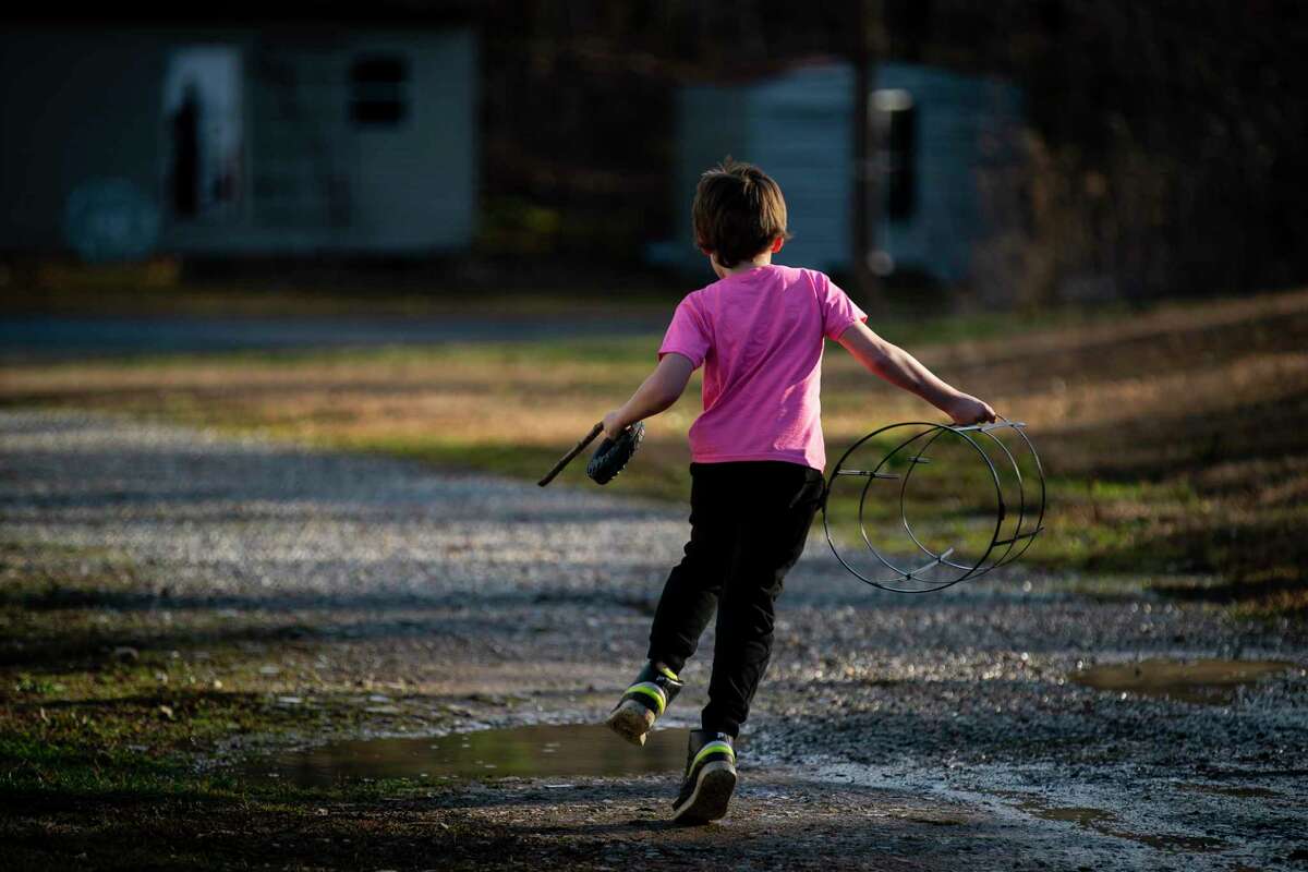 Alex Blanchard's son, 9, plays on his grandfather's property, Monday, Jan. 25, 2021, in Hot Springs, AR. Blanchard's son was five in 2017 when he was assaulted by a 13 year-old boy at Austin Oaks Hospital, a private psychiatric hospital in Austin, TX. Blanchard is now suing the hospital.
