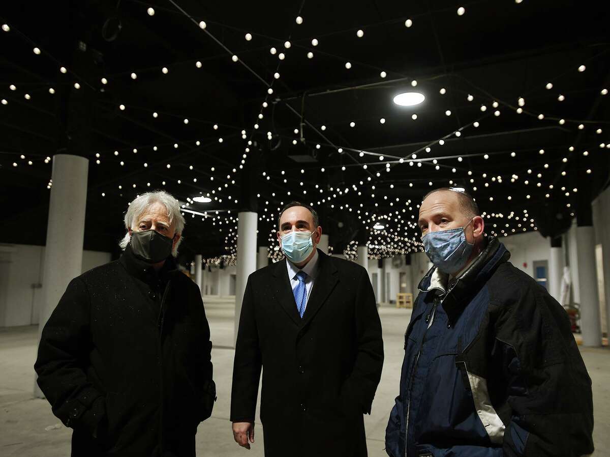 From left; Live Nation Connecticut President Jim Koplik, Hartford Healthcare President and CEO Jeffrey Flaks, and Harbor Yard Amphitheater Principal Howard Saffan tour of the newly named Hartford Healthcare Amphitheater in Bridgeport, Conn. on Tuesday, February 23, 2021. The amphitheater will open for college graduations, the first events to utilize the new venue, on May 15.