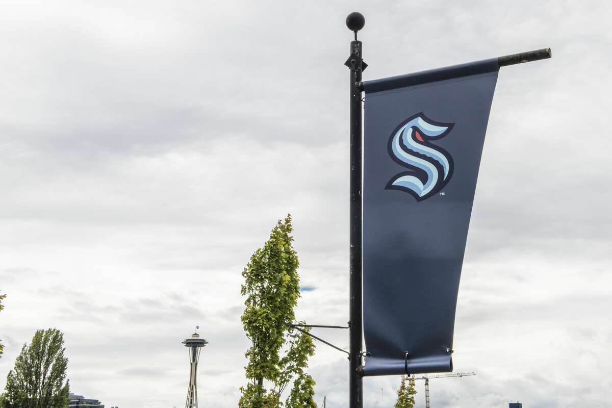 SEATTLE, WASHINGTON - AUGUST 21: The NHL's newest franchise Seattle Kraken flies a flag outside its Team Store with the Space Needle in the background on August 21, 2020 in Seattle, Washington. (Photo by Jim Bennett/Getty Images)