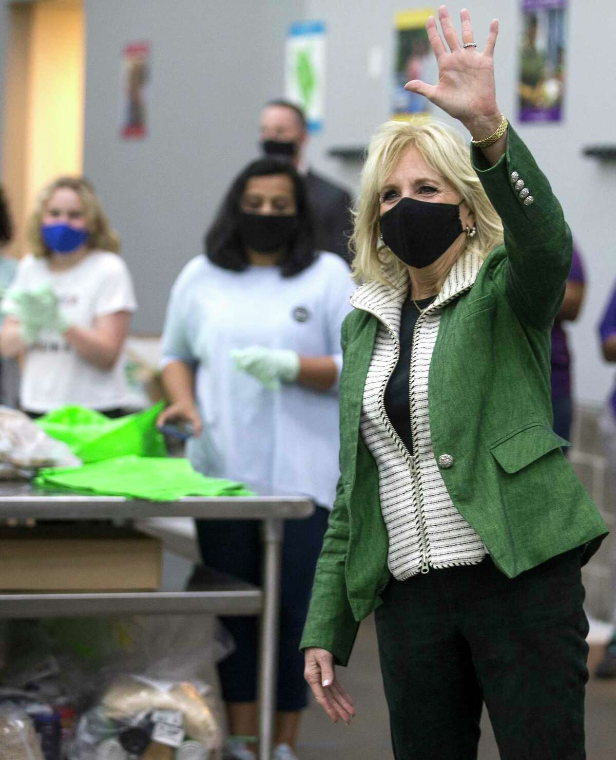 First Lady Jill Biden waves at volunteers as she arrives for a visit to the Houston Food Bank Friday, Feb. 26, 2021 in Houston.