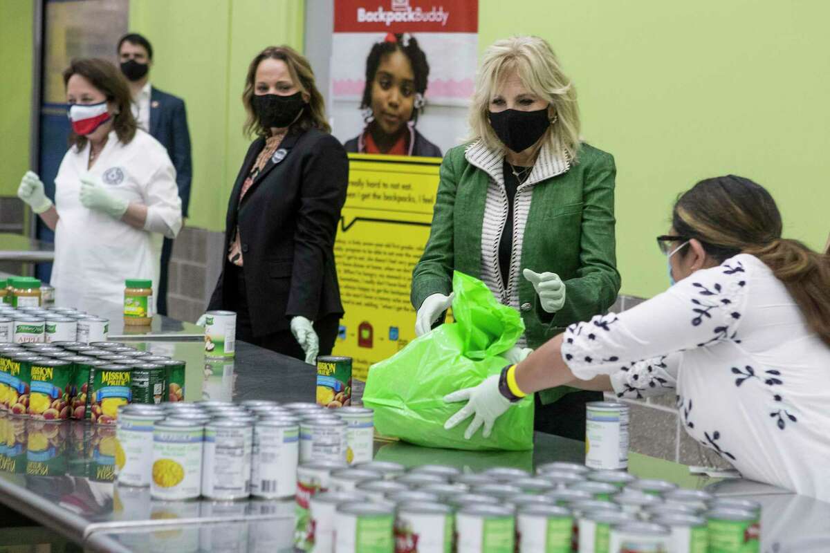 First Lady Jill Biden helps pack a Backpack Buddy bag of food with volunteers at the Houston Food Bank Friday, Feb. 26, 2021 in Houston.