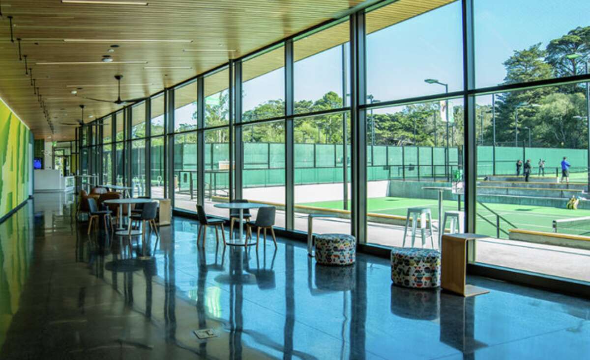 View from the players' lounge out to the courts at the Lisa and Douglas Goldman Tennis Center in Golden Gate Park