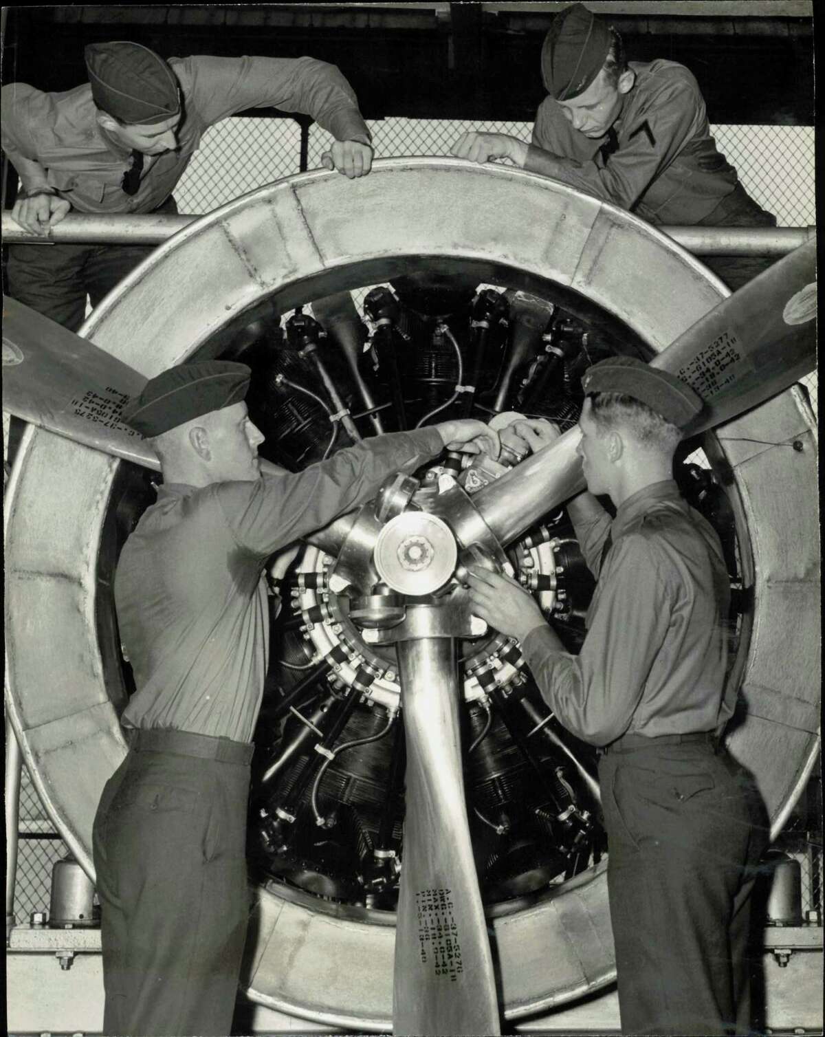 'Trouble-shooting' an air giant - It's a game of hide-and-seek for these flying cadets at Randolph Field, Texas, as they study a huge 900 horsepower plane motor. These cadets are checking a modern two speed supercharger radial engine, the same type used in Uncle Sam's four motored armed bombers.