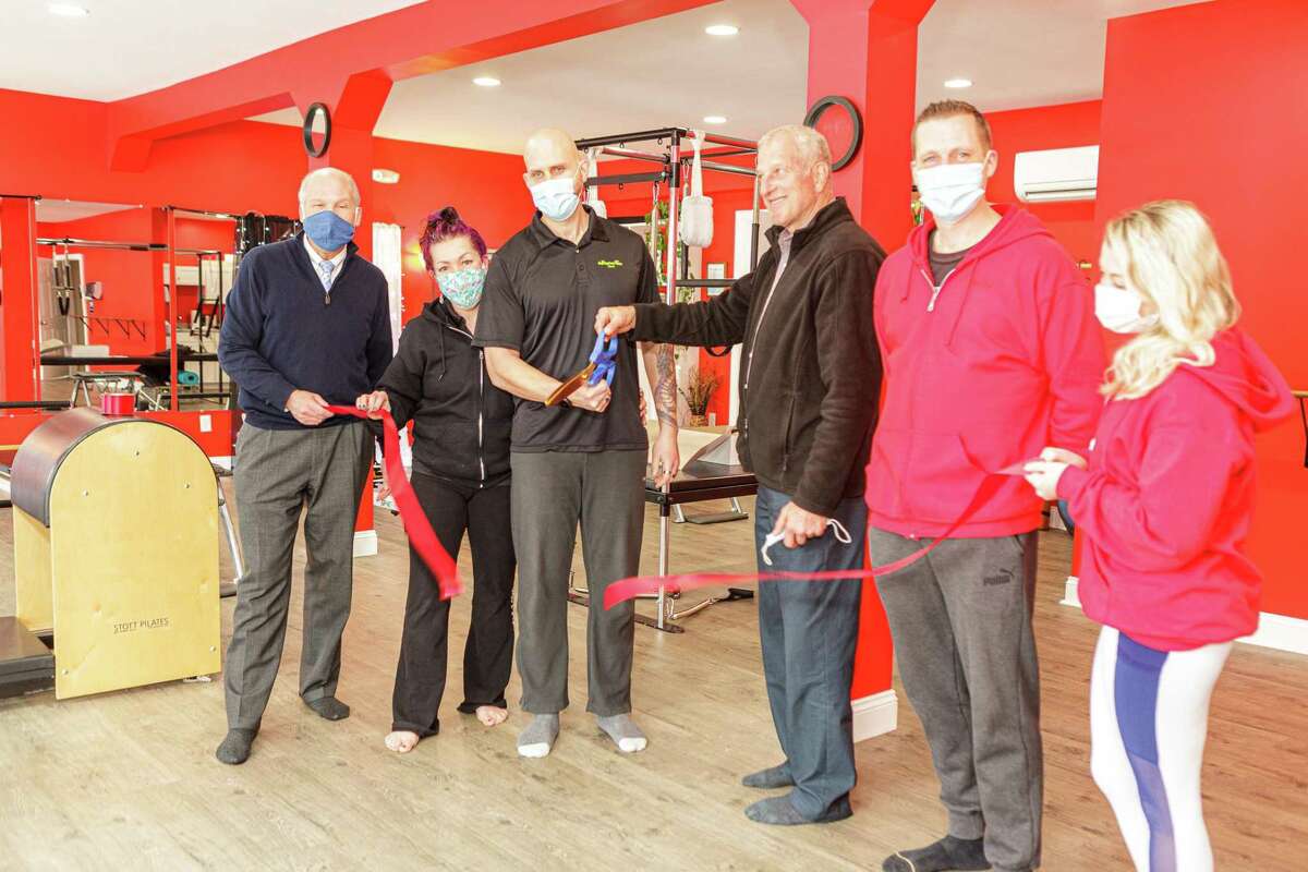Mayor Mark Lauretti and Greater Valley Chamber of Commerce President Bill Purcell, far left, joined Jolene Messere and David Telesco in celebrating the expansion of their Shelton fitness operation with the grand opening of Pilates Barre at its new location at 415 River Road.