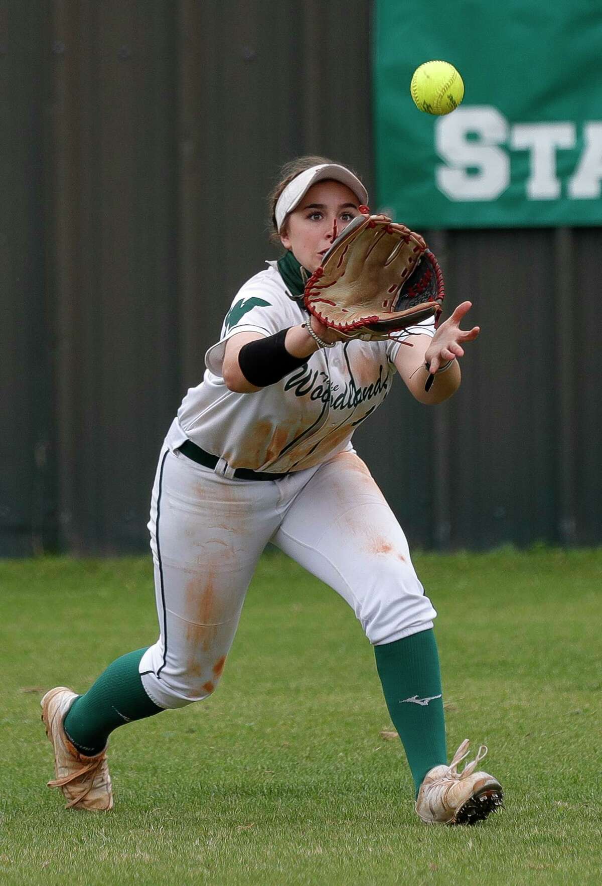 The Woodlands center fielder Gabby Leach (10) field a ball during the first inning of a high school softball game at The Woodlands High School, Saturday, Feb. 27, 2021, in The Woodlands.
