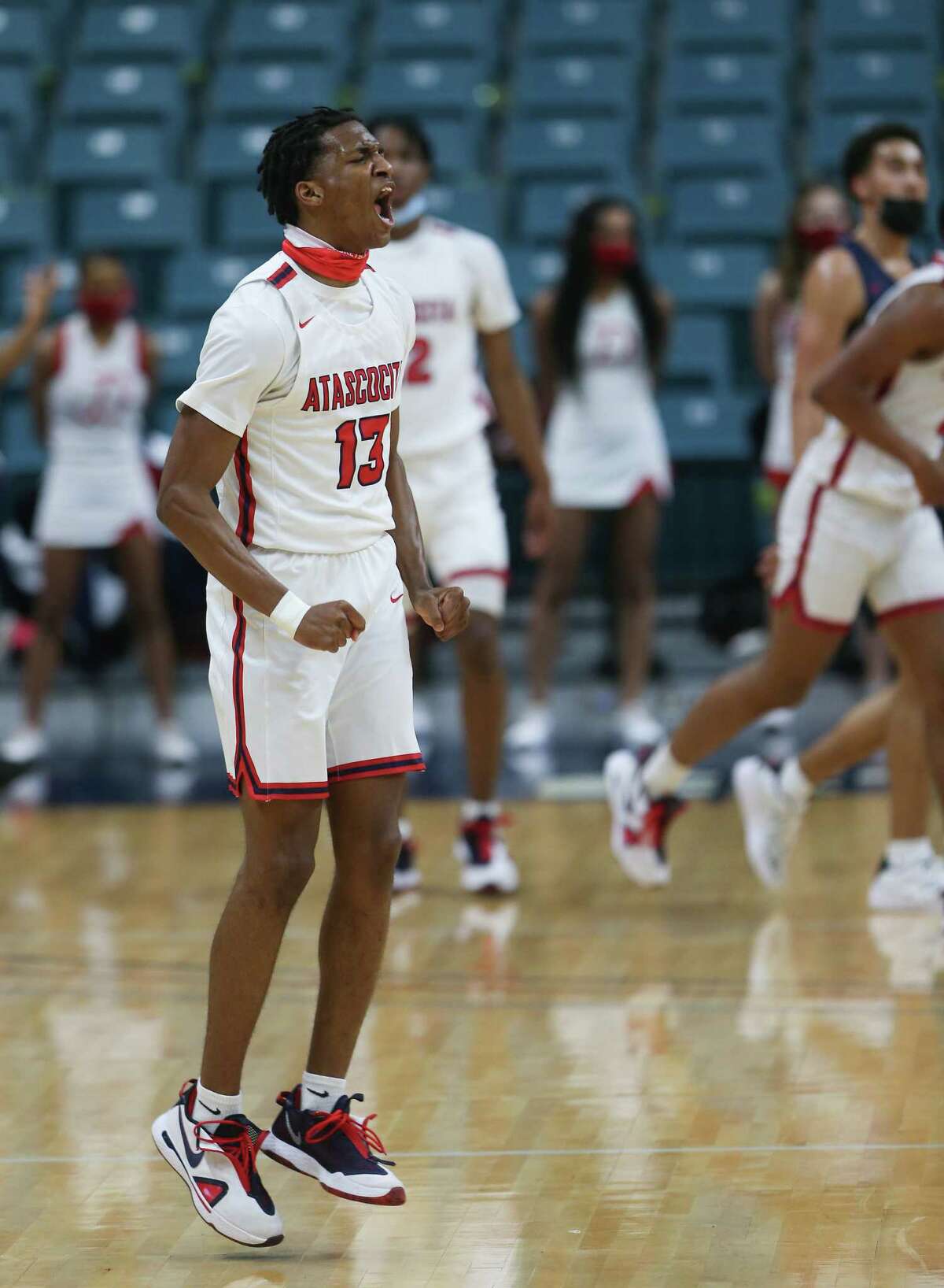 Atascocita guard Justin Collins reacts to sinking a three pointer against Dawson High School during 6A regional quarterfinals playoff game at Merrell Center in Katy on Saturday, Feb. 27, 2021. Atascocita won the game 55-54.