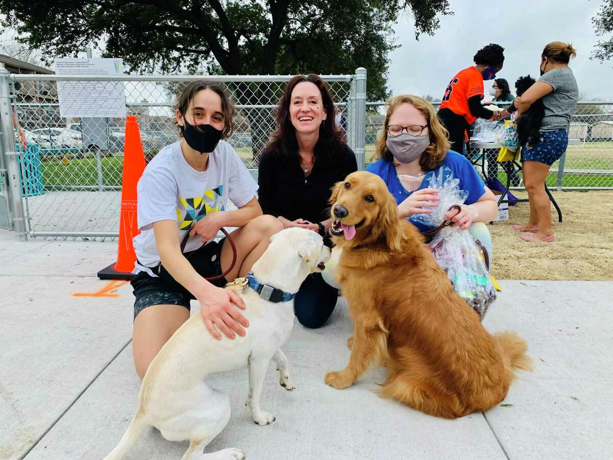 Jessica Rosenthal (far left), Rebekah Wilson (far right) and dog wellness expert Blair Johnson (center) were among the people gathered to celebrate the ribbon cutting for Westchase District's Sneed Dog Park.