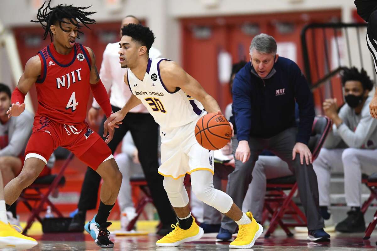 UAlbany guard Chuck Champion (30) looks to drive on NJIT guard Zach Cooks in an America East Tournament game Saturday, Feb. 27, 2021, in Hartford, Conn. UAlbany won the game, 76-66. (Steve McLaughlin/Hartford Athletics)