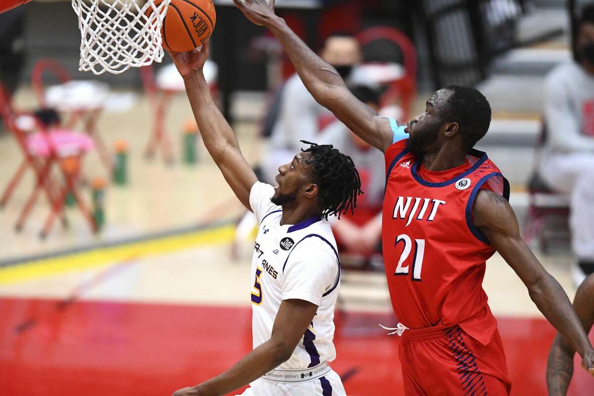 UAlbany's Jamel Horton goes for a layup under the outstretched arm of NJIT's Antwuan Butler in an America East Tournament basketball game Saturday, Feb. 27, 2021, in Hartford, Conn. UAlbany won, 76-66. (Steve McLaughlin/Hartford Athletics)