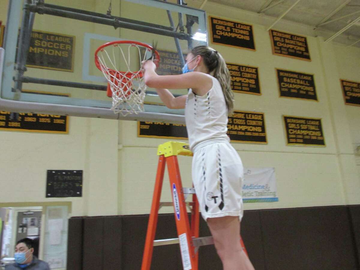 Thomaston high scorer Emma Kahn cuts down her piece of the BL Championship net after the Bears' win over Northwestern Saturday afternoon.