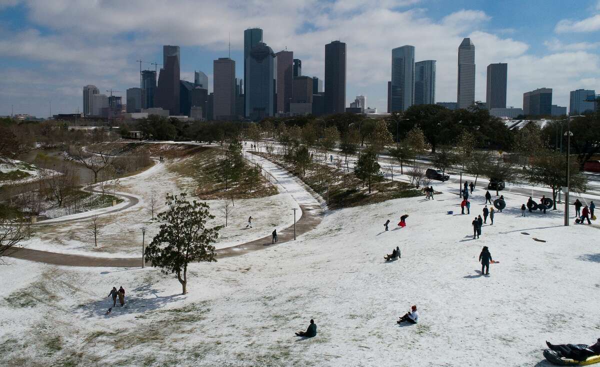 People sled at Buffalo Bayou Park on Feb. 15.
