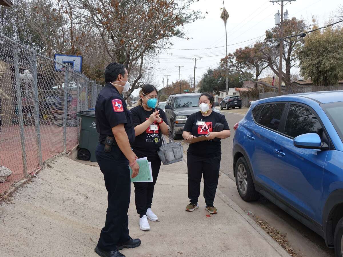State nurses coordinate with a Laredo paramedic outside a home on Salinas Avenue.