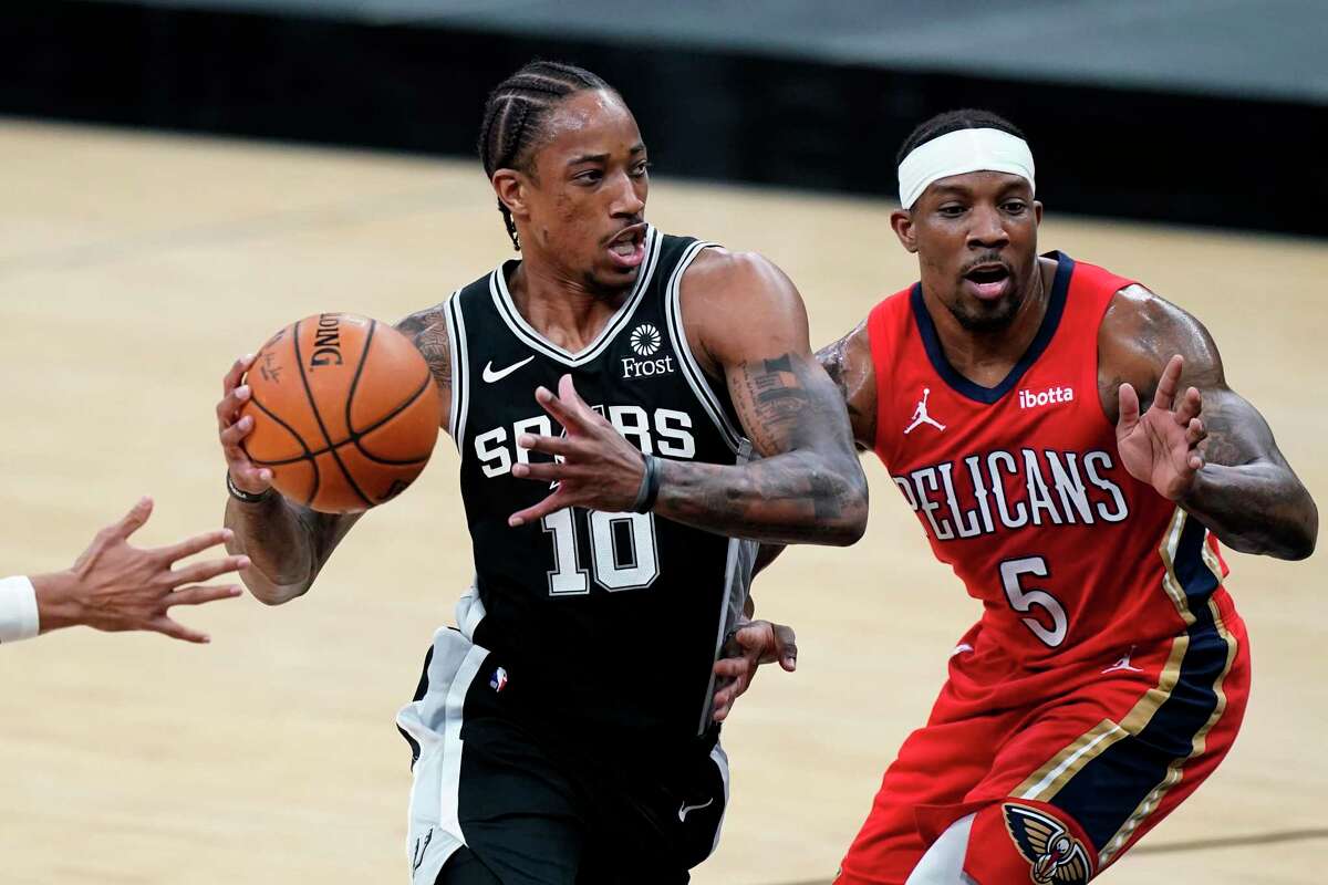 San Antonio Spurs forward DeMar DeRozan (10) drives to the basket past New Orleans Pelicans guard Eric Bledsoe (5) during the first half of an NBA basketball game in San Antonio, Saturday, Feb. 27, 2021. (AP Photo/Eric Gay)