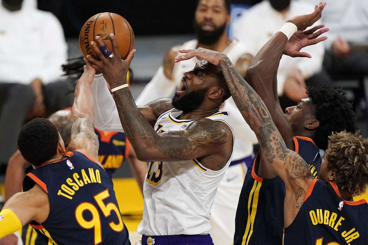LeBron James, who spent a lot of time on the bench thanks to L.A.’s big lead, is fouled by the Warriors on a drive.